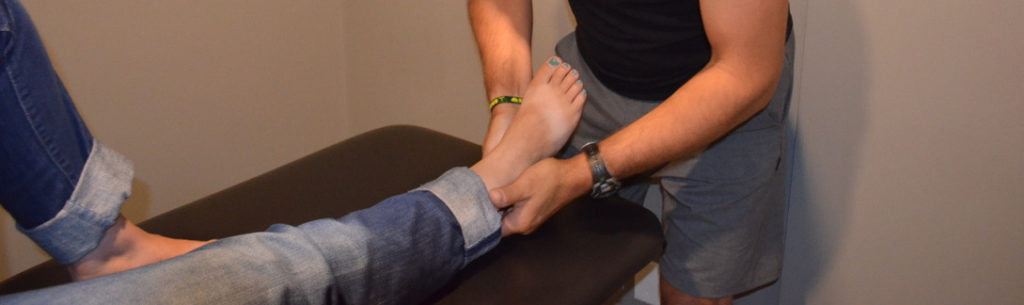Physiotherapist providing manual therapy on patient's foot